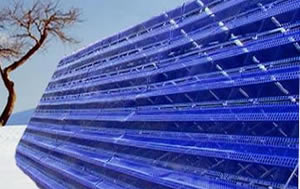 Steel snow fence on the mountains made from blue color windbreak panel